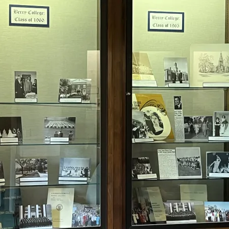 Display case with black and white photos and memorabilia from Berry College Classes of 1960 and 1963.