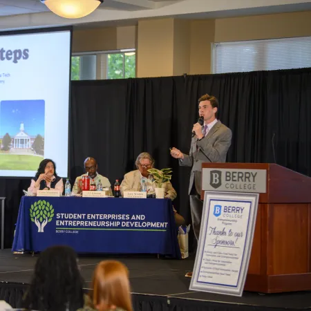 Presenter speaking at Berry College entrepreneurship panel with slide titled Next Steps and audience in foreground