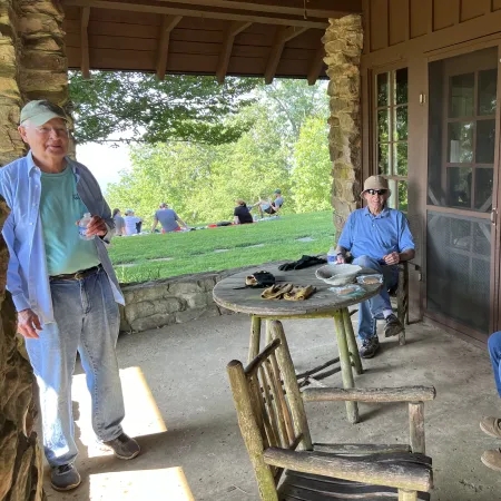 a group of men sitting outside a house