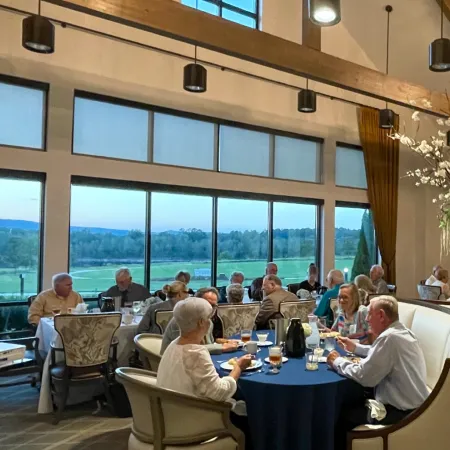 a group of people sitting around a table with drinks