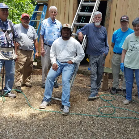 a group of men standing outside a house