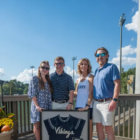 a group of people posing for a photo on a deck