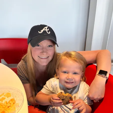 a woman and a child holding a turtle