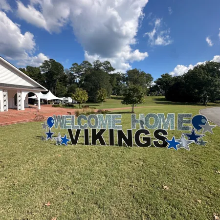 a sign in a grassy area