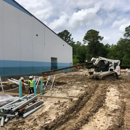 a construction site with a truck and a building