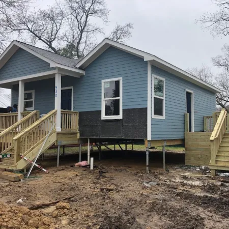 a blue house with a slide in front of it