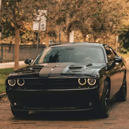 a black car parked on a brick road