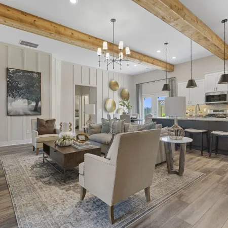 a large living room with a bar and chairs