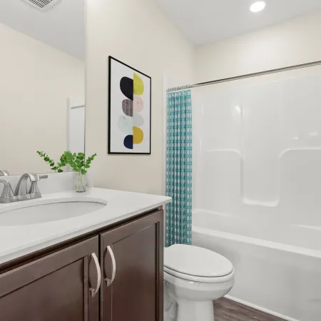 a bathroom with a tub sink and toilet