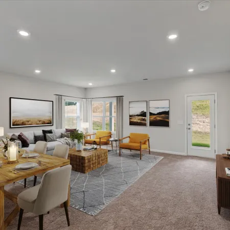 Spacious modern living room with wooden dining table, gray sofa, yellow chairs, and wall art under recessed lighting.