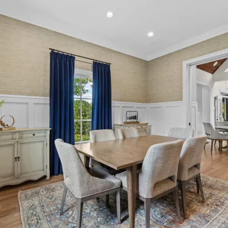 a dining room with a table and chairs