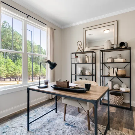 a room filled with furniture and a large window