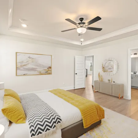 a bedroom with a bed and a fan