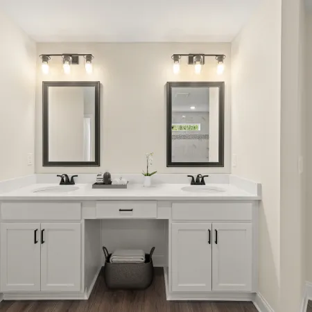 a bathroom with white cabinets