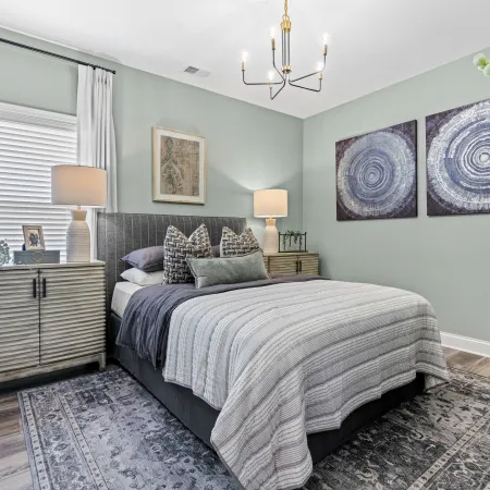 a bedroom with a bed and lamps