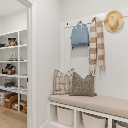 a room with a white table and shelves with objects on it
