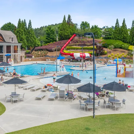 tables with umbrellas in front of the water park at NatureWalk