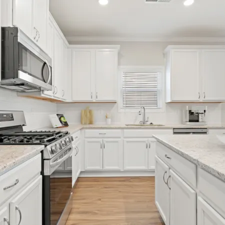 a kitchen with white cabinets