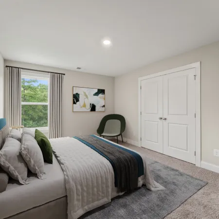 a bedroom with a bed and a chair