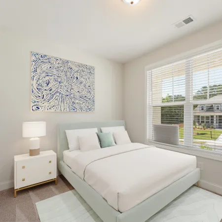 a bedroom with a bed and a lamp