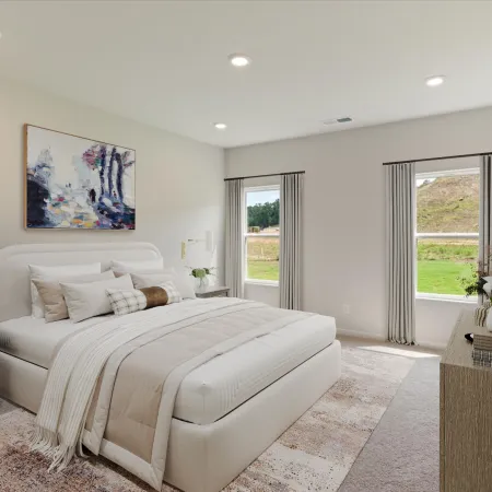 Bright modern bedroom with large bed, neutral tones, abstract wall art, two windows, and wooden dresser with round mirror.
