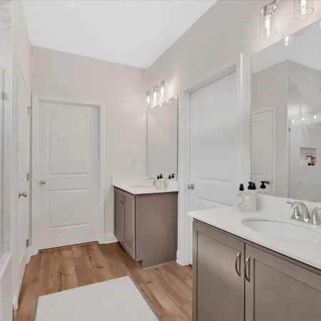 Modern bathroom featuring marble accents, double sinks, and sleek cabinetry for stylish decor.