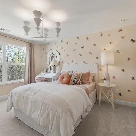 a bedroom with a bed and a lamp