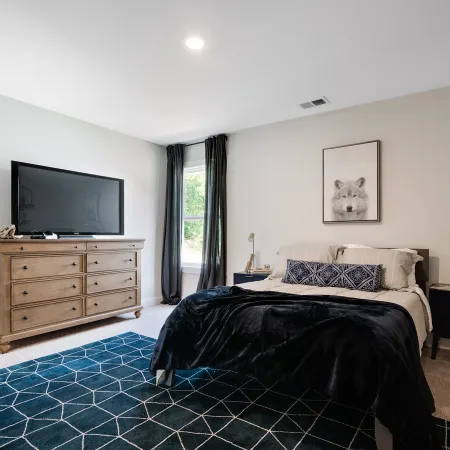 a bedroom with a bed in a room