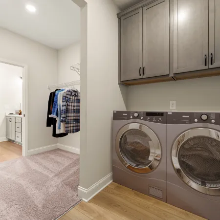 a room with a washing machine and a rug