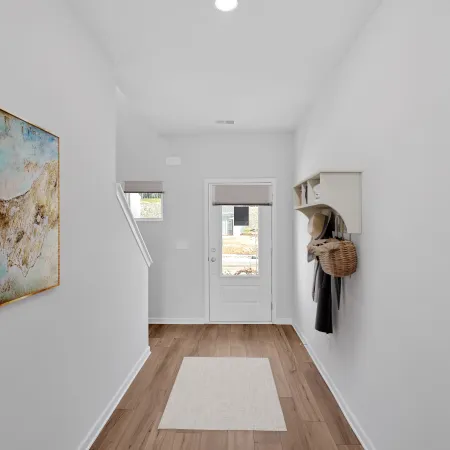 Bright entryway featuring modern decor, artwork, and natural light showcasing a welcoming atmosphere.