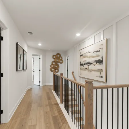 a hallway with a wood railing