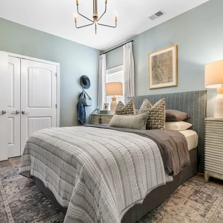 a bedroom with a bed and lamps