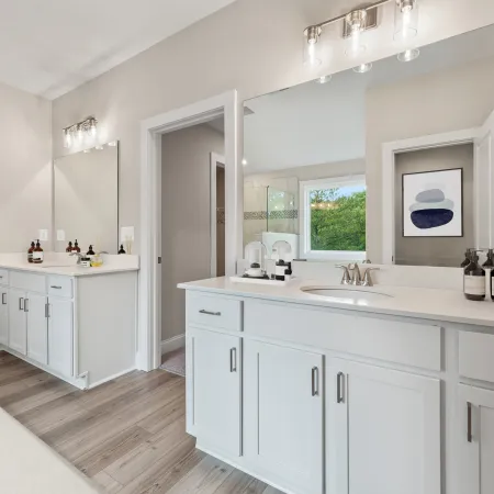 a bathroom with white cabinets