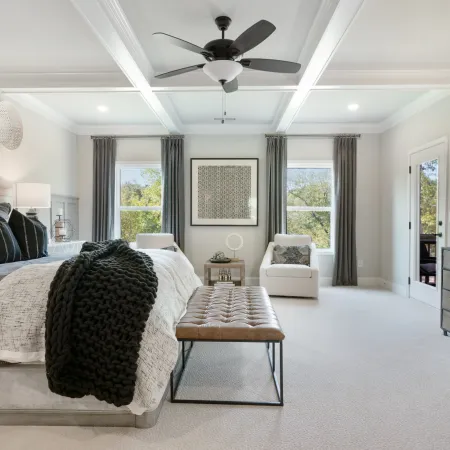 a bedroom with a bed and a fan