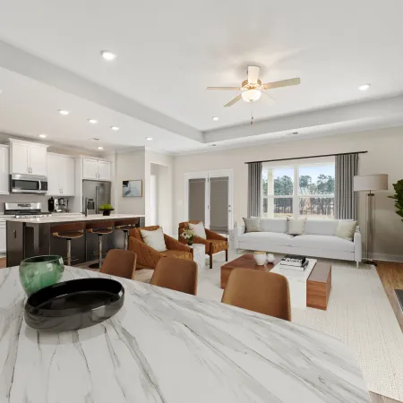 a large living room with a large white table and a large white couch