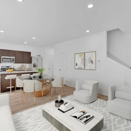 Modern living room and kitchen with stylish furniture and bright natural lighting.