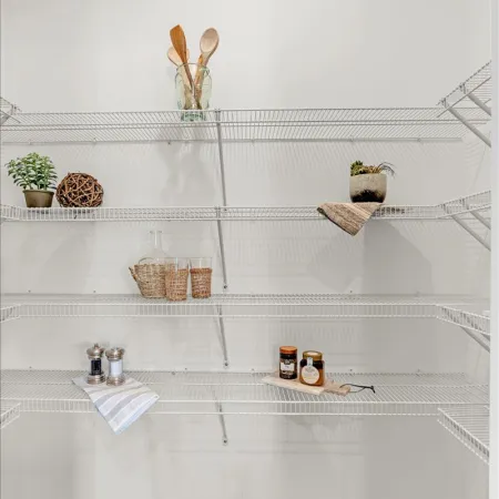 a white shelf with objects on it