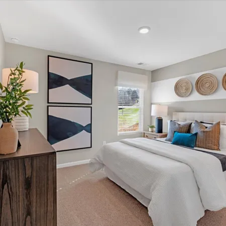 a bedroom with a bed and a lamp