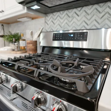 a stove top oven sitting inside of a kitchen