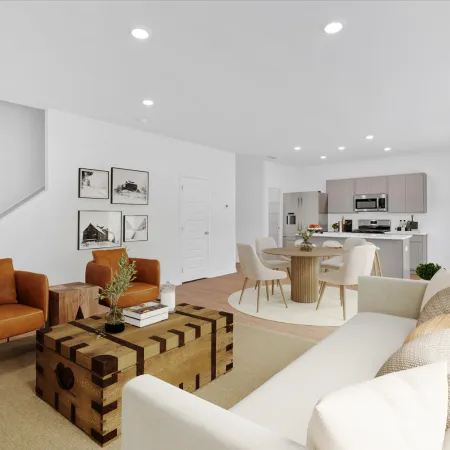 Modern living room with orange chairs, wooden table, and minimalistic decor in bright, airy space.