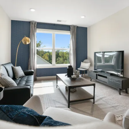 a living room filled with furniture and a large window