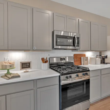 Modern kitchen featuring stainless steel appliances and light-colored cabinetry with stylish decor elements.