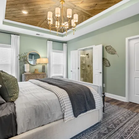 a bedroom with a bed and a chandelier