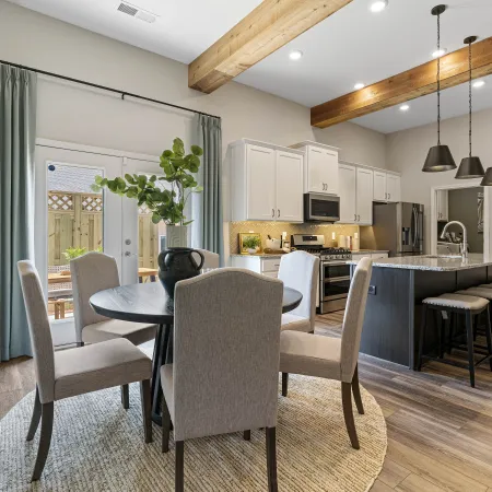 a kitchen with a dining table and chairs