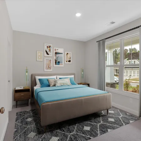 Stylish modern bedroom featuring a blue bed, artwork, and natural light.