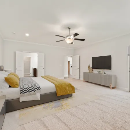 a bedroom with a bed and a tv