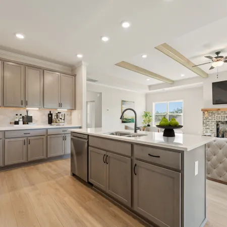 a kitchen with a fireplace and a wood floor