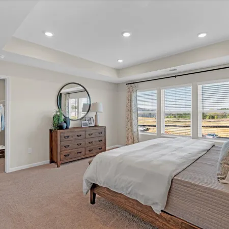 a bedroom with a bed and a mirror