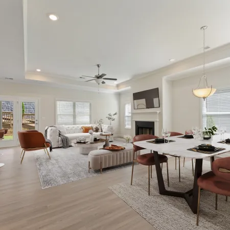 a large living room with a dining table and chairs