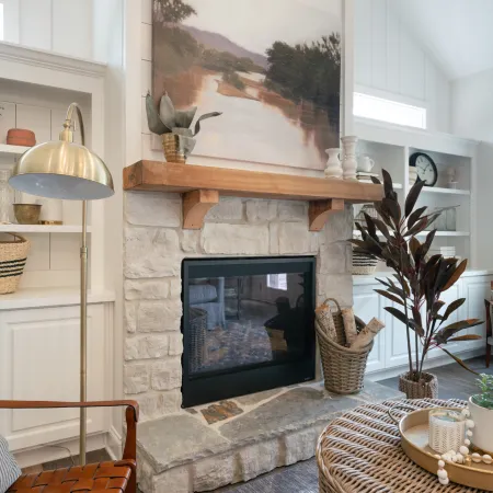 a fire place sitting in a living room filled with furniture and a fireplace